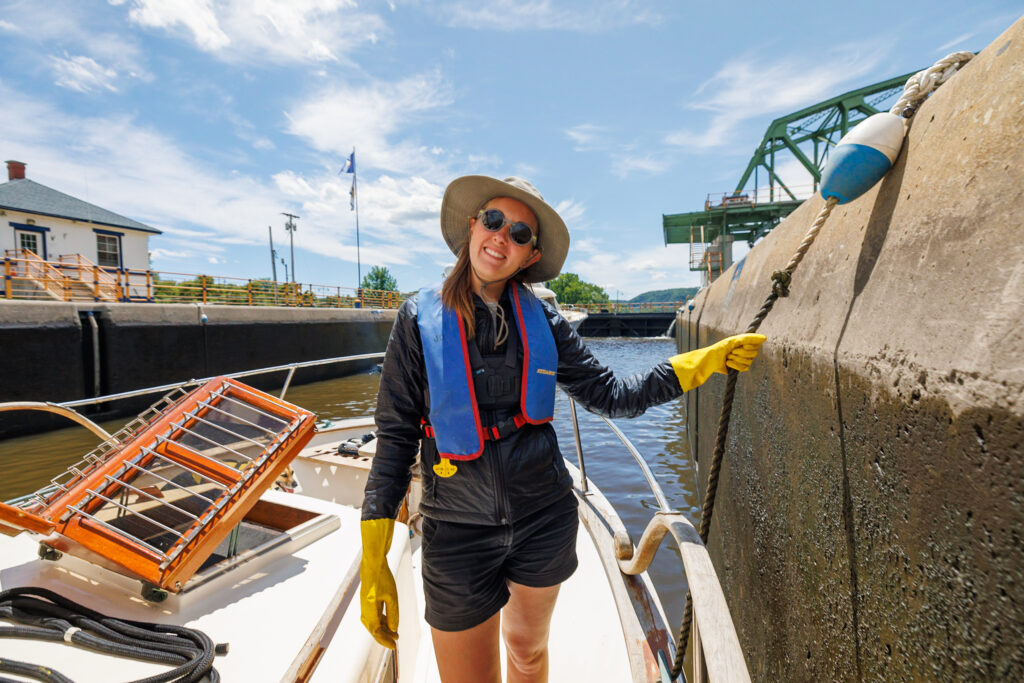 Jenn using gloves while learning how to lock a boat