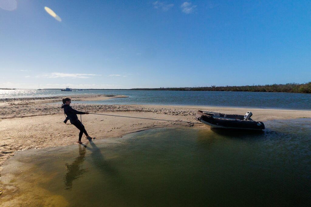 Jenn pulling the dinghy, with all of the dinghy essentials onboard