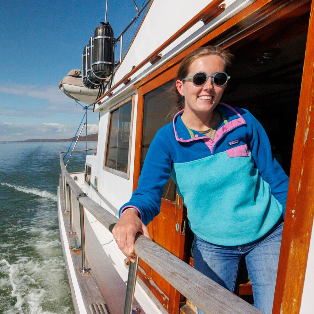 Jenn wearing her Patagonia jacket on the boat, one of the best gift ideas for boaters