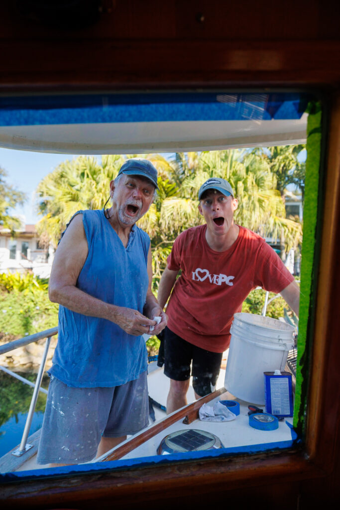 Keeping up with boat maintenance as Elliot and our friend Bill re-caulk our front windows after finding a small leak.