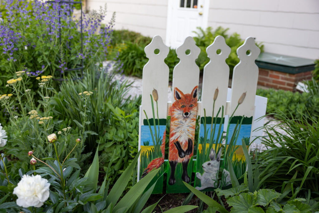 picket fence with fox and rabbit drawn