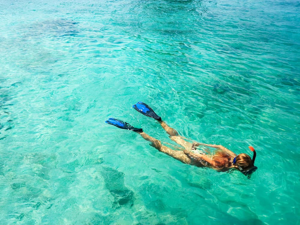 Woman snorkeling in Florida with crystal clear waters.
