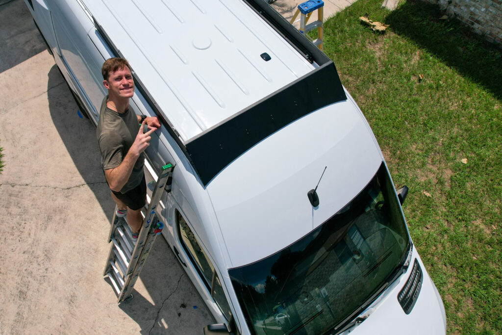 elliot on ladder installing front of roof rack