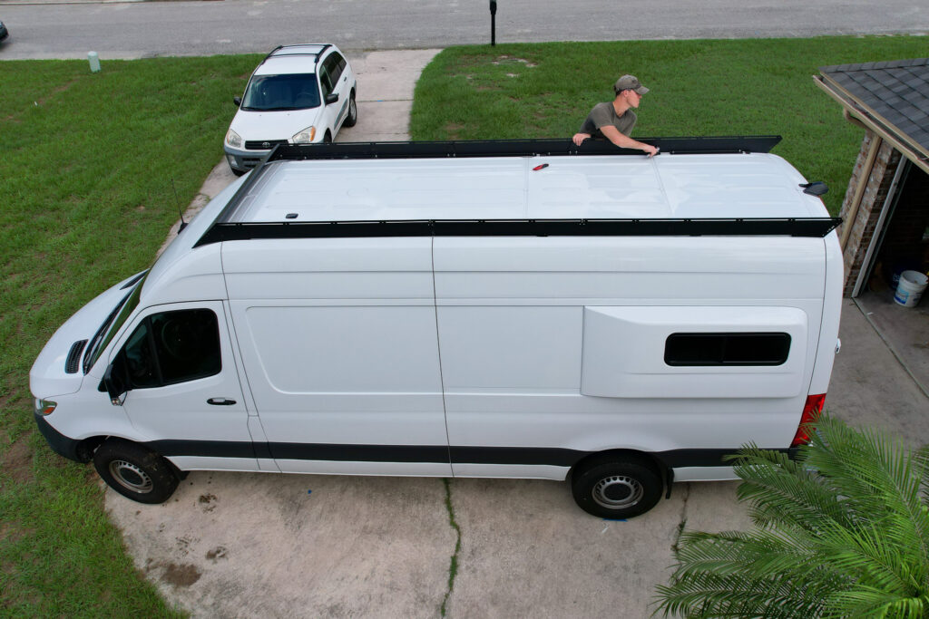 elliot on ladder installing roof rack