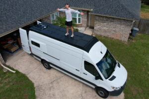 elliot standing on pivot roof rack panels