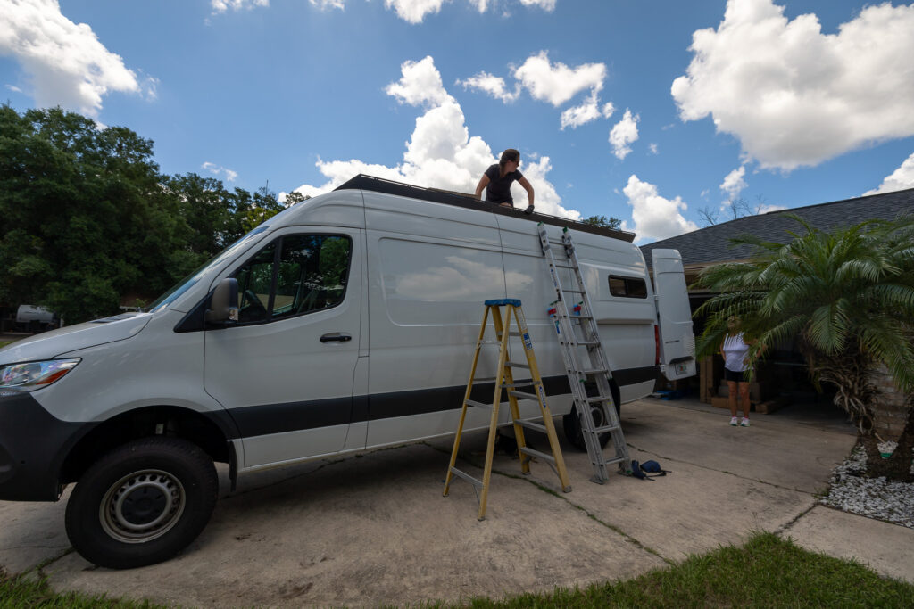 ladders and jen on roof while building roof rack