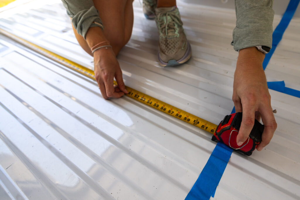 Jennifer measuring the width of the bed