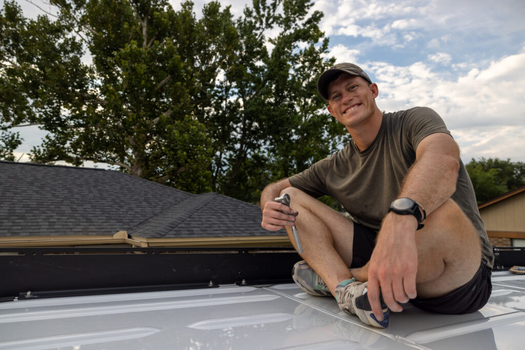 elliot on van installing roof rack