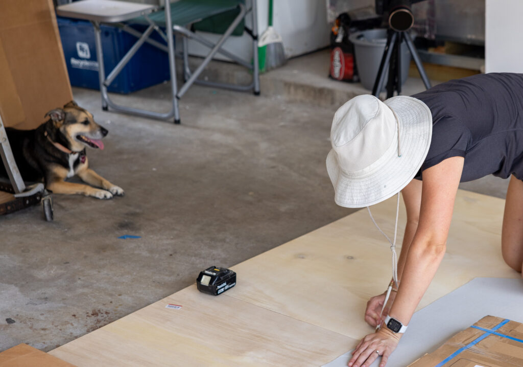 jennifer and ollie marking our floor on our plywood