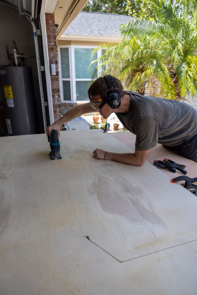 elliot cutting center of plywood with a jig saw