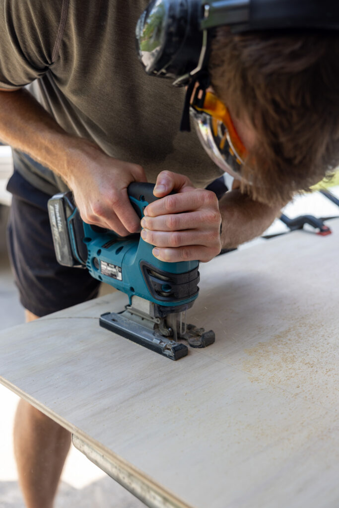 elliot cutting the plywood with a jig saw