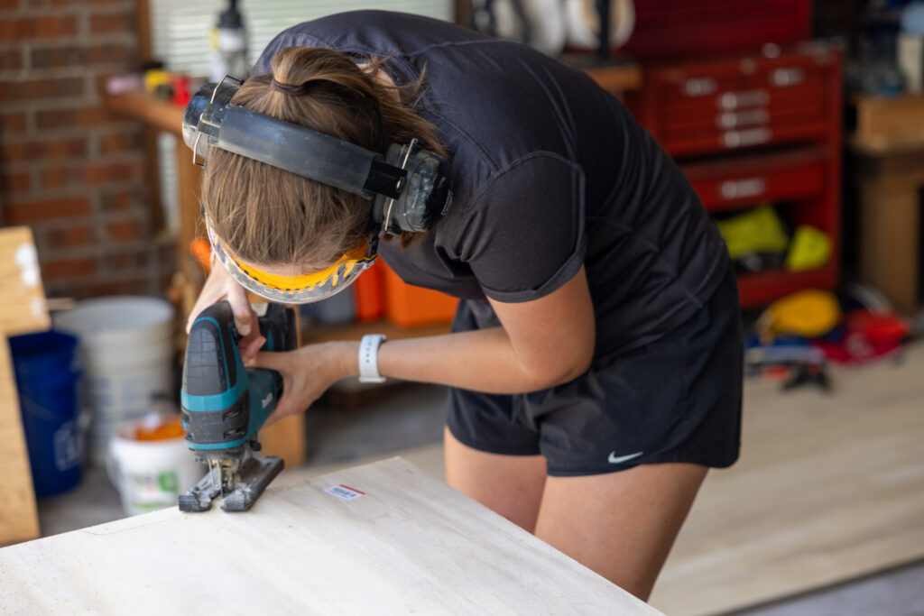 jen cutting the wood with a jigsaw