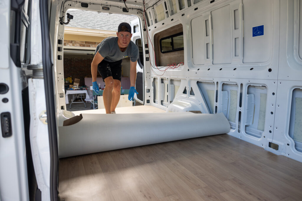 elliot rolling out the floor in the camper van