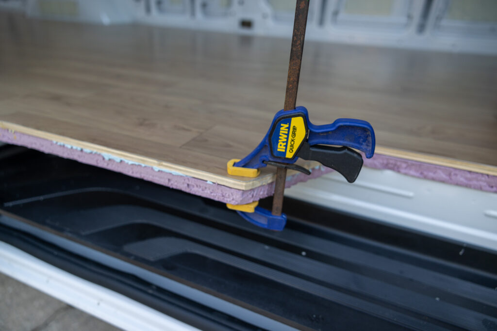 clamped edge of camper van floor while it cures