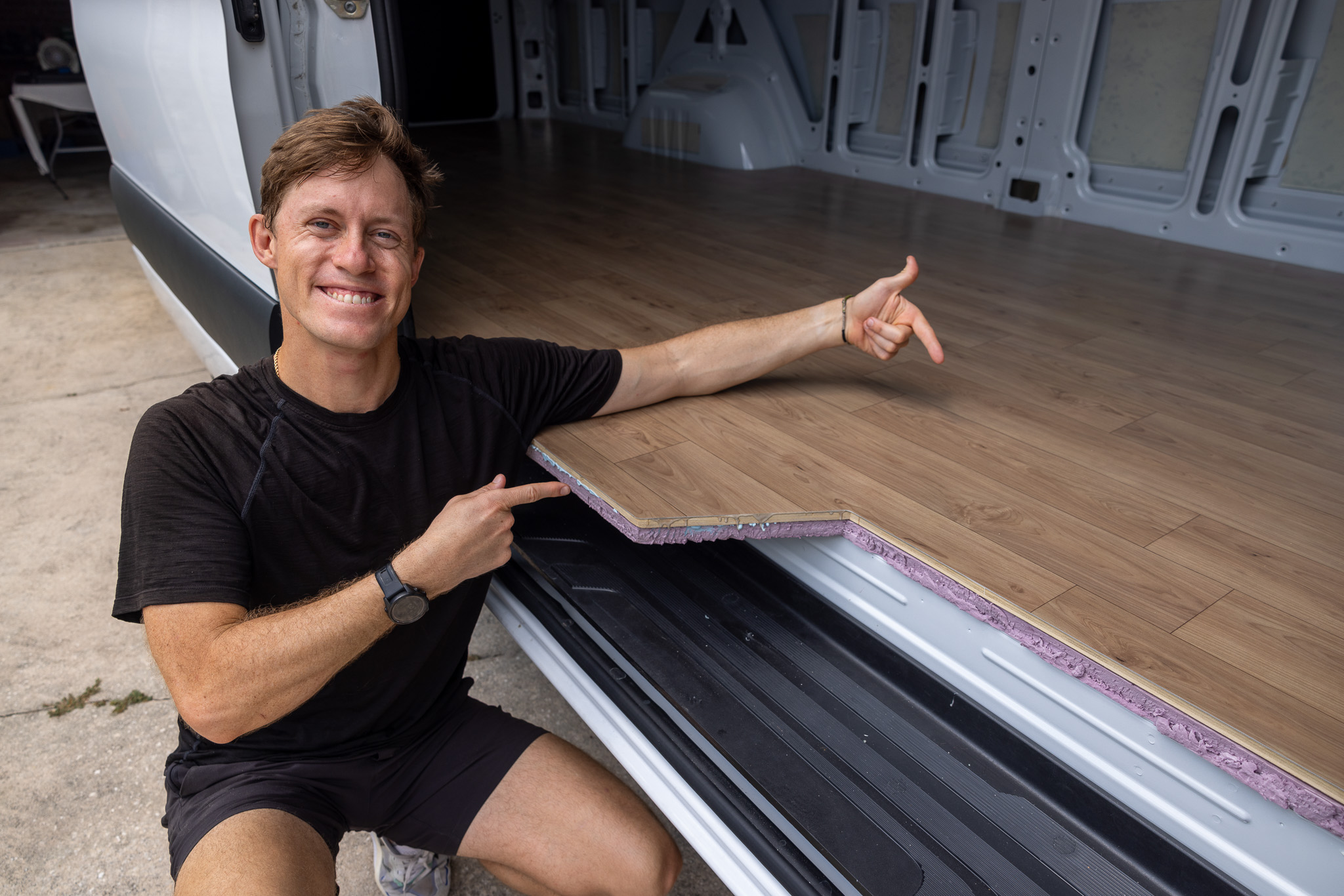 elliot pointing at finished camper van floor