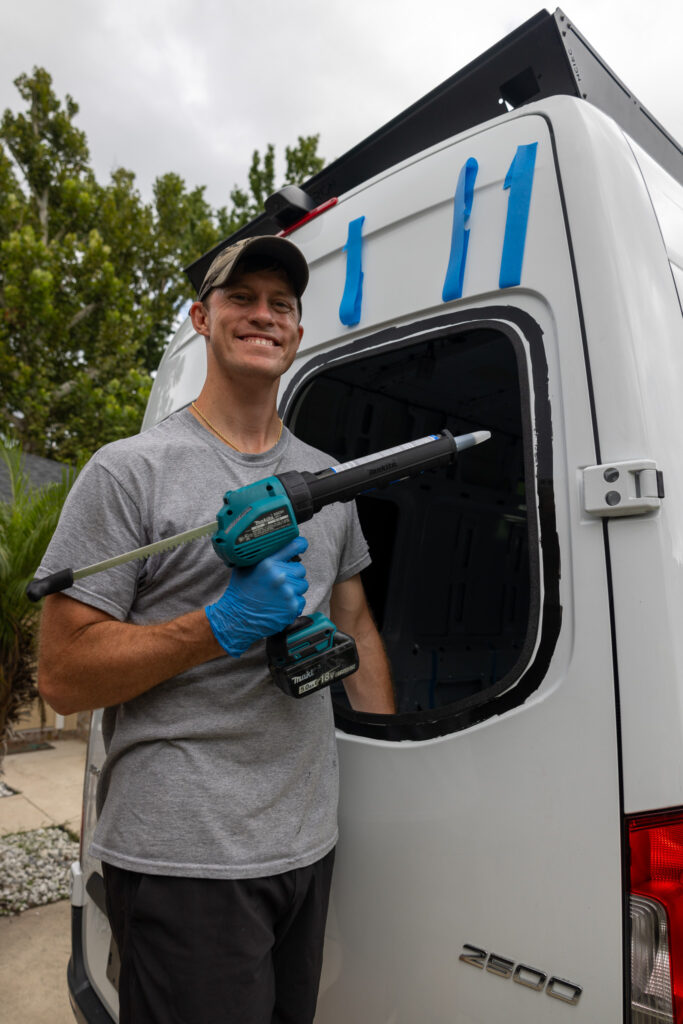 elliot holding caulk gun